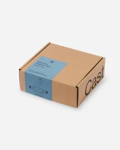 Closed kraft cardboard box for a Windsor Angled TRV in Natural Pewter, with a blue label showing a valve line drawing, on a white background.