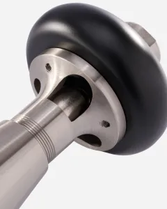 Close-up of a Windsor radiator valve in Satin Nickel with a black round head, showing the machined collar, screw holes and ringed body.