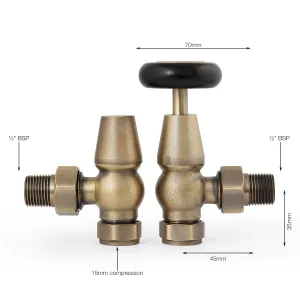 Pair of Windsor angled manual radiator valves in Natural Brass, one with a black wheel head, on white with dimensions marked.