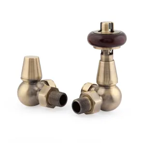 A pair of Windsor corner radiator valves in Antique Brass, one thermostatic with a dark wooden head and one lockshield, on a white background.
