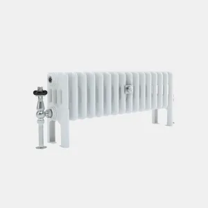 Low white Florence 4 Column steel column radiator on feet, with a chrome angled valve with black head and a central wall stay, on a plain grey background.